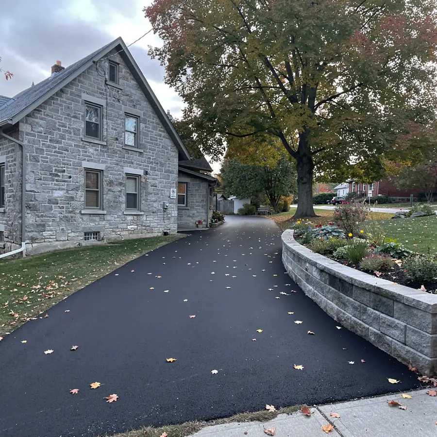 Asphalt driveway beside Elora limestone house
