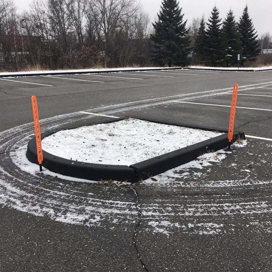 Asphalt island curb with snow markers