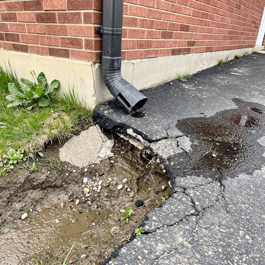 Downspout washout cracking edge of driveway