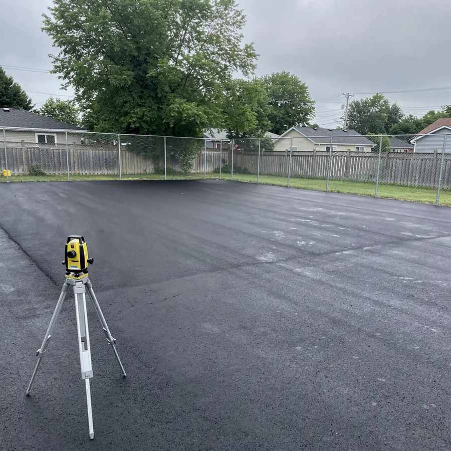 Laser-graded asphalt tennis court before coating