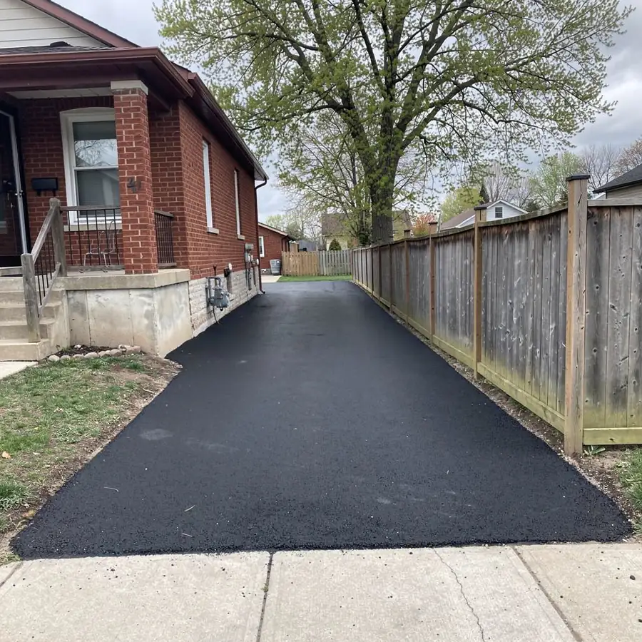 Narrow asphalt driveway near downtown Acton